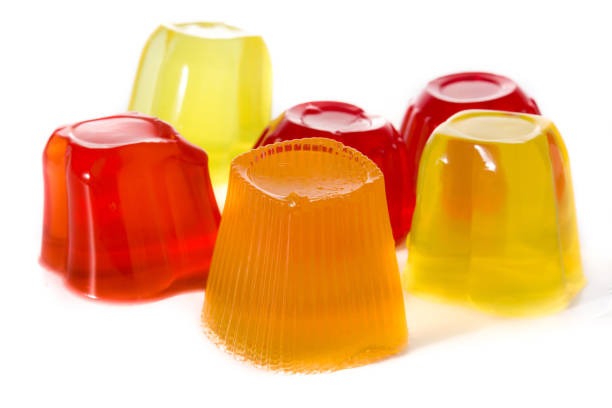 Jellies of different flavors in a plastic cups isolated on white background