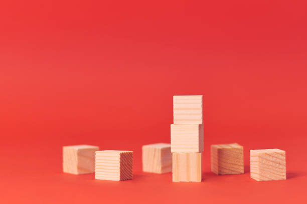 istock wood cube stacking. Business concept growth success process on red background, copy space. 1205564010