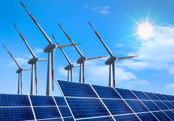 Photovoltaic system and wind turbine in front of blue sky
