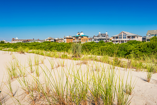 Beach and row of houses in the city of Cape May New Jersey USA on a sunny summer day.