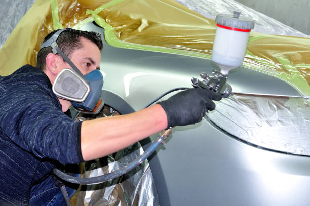istock Professional male painting silver car. 1205567381