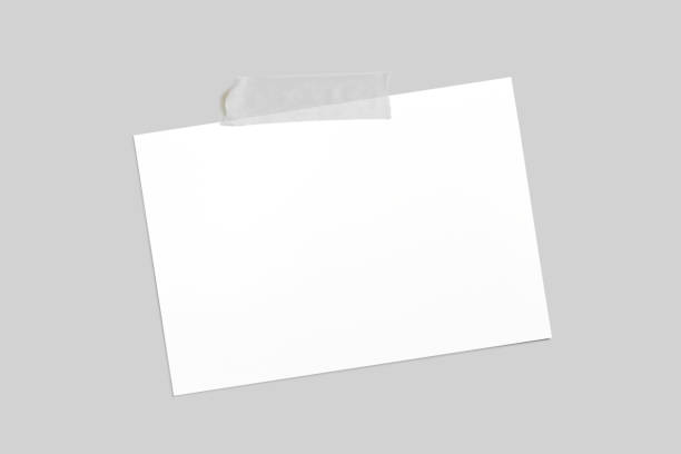 istock Blank horizontal photo frame with scotch tape isolated on grey paper background as template for graphic designers presentations, portfolios etc. 1205567418