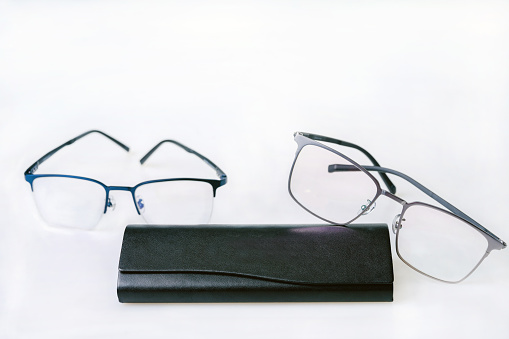 Typical glasses and frames of  titanium metal  glass and black frame  -   on white background  (  composition)