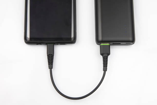 istock powerbank charges a smartphone battery on a white background. digital technologies and devices 1205568757