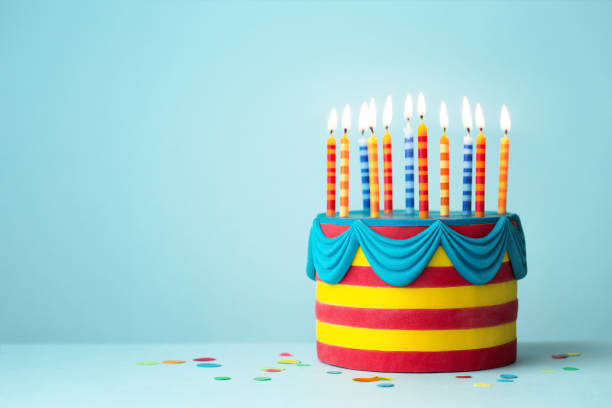 istock Brightly colored birthday cake with candles 1205574795