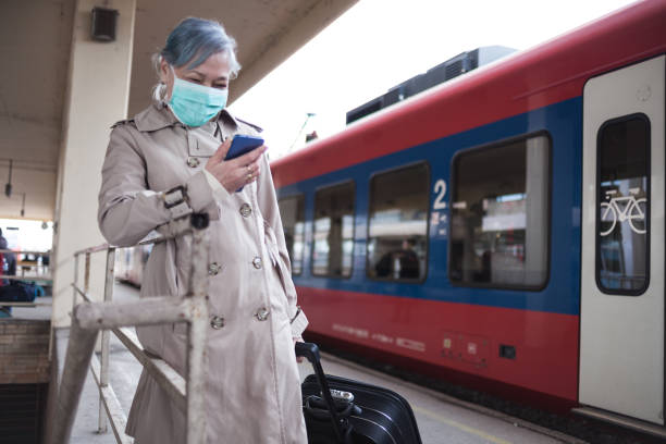 istock Senior woman surfing the net on train station 1205576433