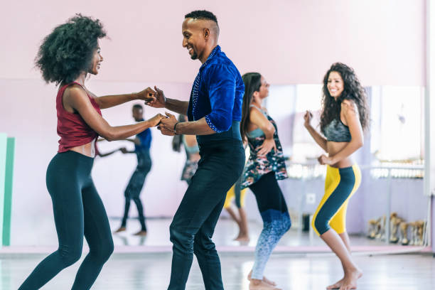 Couple dancers practicing in studio, holding hands Couple dancers practicing in studio, holding hands dance studio instructor stock pictures, royalty-free photos & images