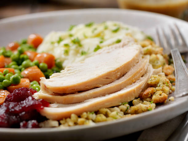 istock Roast Turkey Dinner With Stuffing,Mashed Potatoes, Cranberry Sauce, Peas, Carrots and Gravy 1205578436