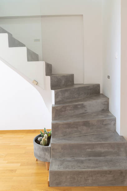 istock Microcement grey colour on staircase with matt finish, in combination with white walls and natural wooden floo 1205578632