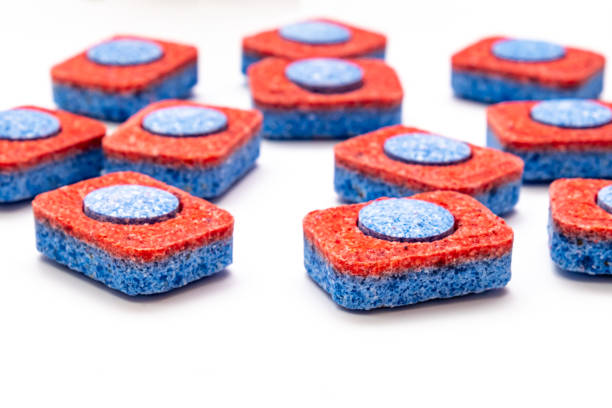 istock Many red and blue dishwasher soap tablets on white background, kitchen equipment and solutions for washing dishes, housekeeping concept 1205578735