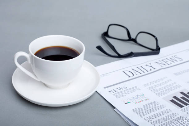 istock coffee and newspaper on office desk 1205583156