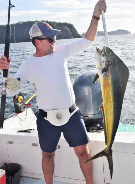 istock Fisherman with dolphin fish in Costa Rica 1205583386