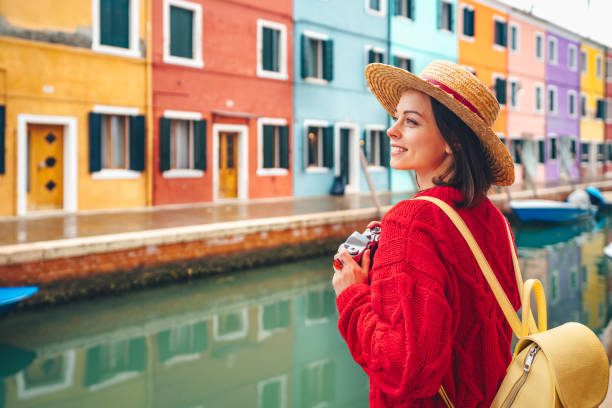 Beautiful girl with a retro camera in Italy