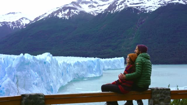 Couple looking at scenic view of Perito Moreno Glacier in Patagonia