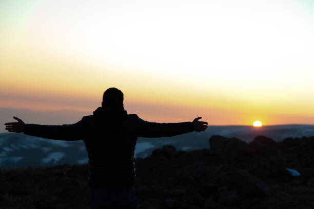 istock happy man in mountain at the sunset 1205586427