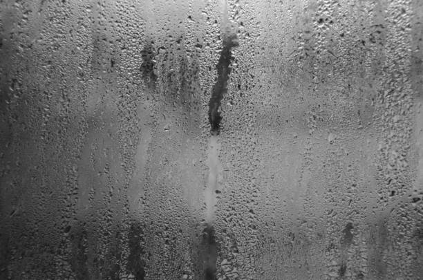 istock Indoor wet window on which droplets of water slide 1205588699