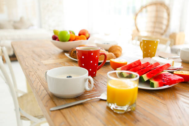 istock Coffee with fruit, cereal and croissant on wooden table background 1205588941