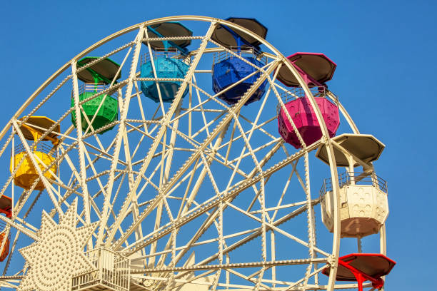 istock Ferris wheel with color cabins in amusement park 1205589936