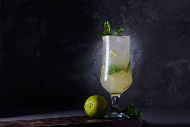 istock Refreshing lime cocktail with mint and ice on a dark background. Soft drink with lime and mint. Close-up. 1205591204