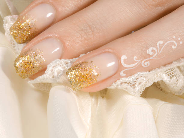 istock Woman's hand with golden manicure 1205592395