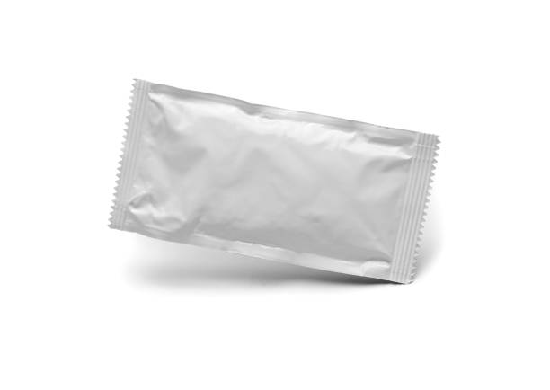 blank white condiment packet floating isolated on white background - sachet photos et images de collection