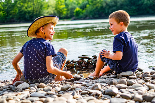 istock Boys enjoying at river bank 1205593520