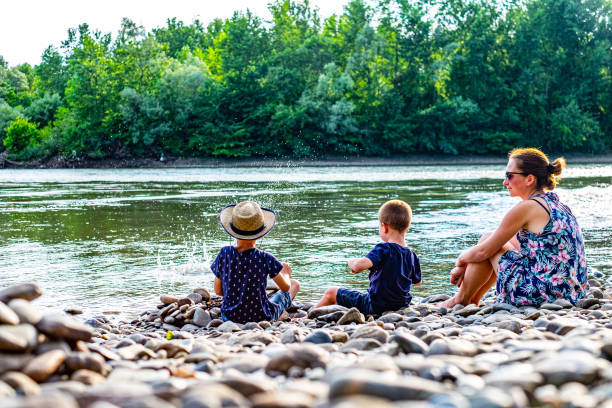 istock Kids love throwing rocks in water 1205593705