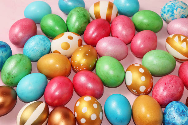 istock Decorated golden easter eggs on a pink background. Minimal holiday concept. Happy easter background. Creative painting of eggs at home, the idea of simple drawings for coloring, a place for text, a postcard, a banner for the screen 1205593730