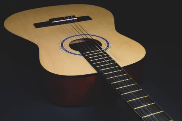 istock Acoustic guitar on the black background. musical instrument 1205595618