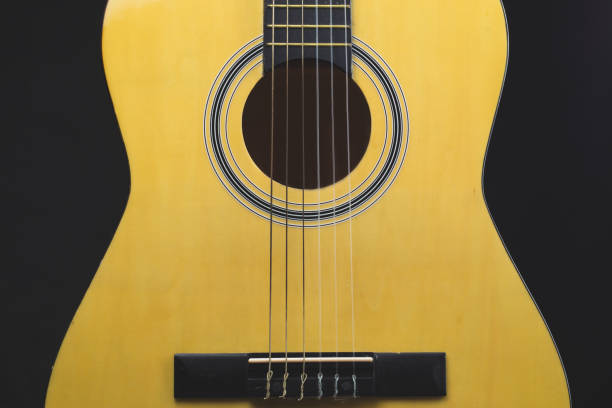 istock Acoustic guitar on the black background. musical instrument 1205596144