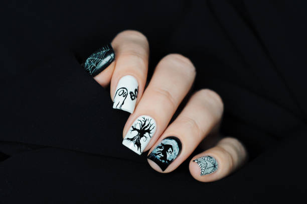 istock Black and white manicure on Halloween with tree, witch, moon, spider web and ghost BOO 1205600483