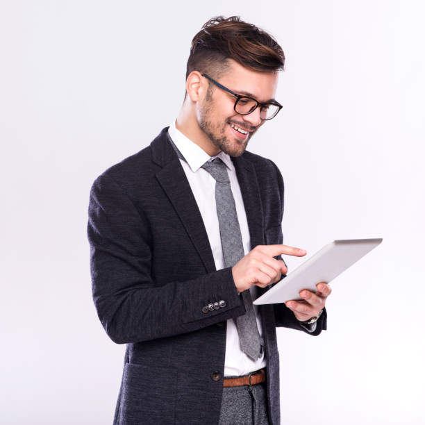 istock Young male businessman looking at digital tablet display 1205602879