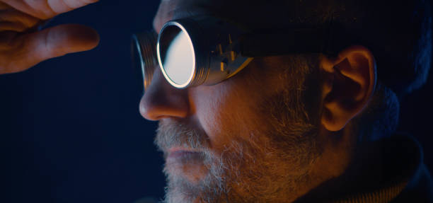 istock Man in safety goggles looking away 1205603404