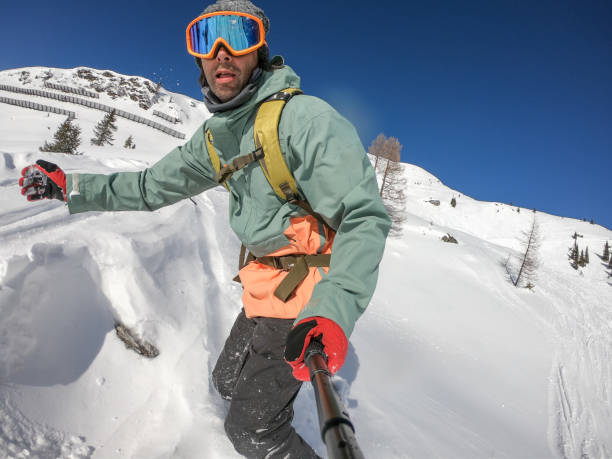 istock Snowboarder on snow and rocks 1205609208