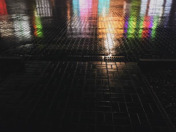istock Abstract colorful background. Wet asphalt texture 1205610066