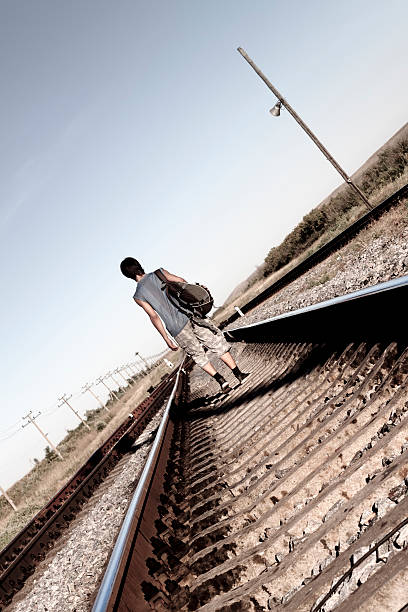 istock Teen boy walking on rail road 120561276