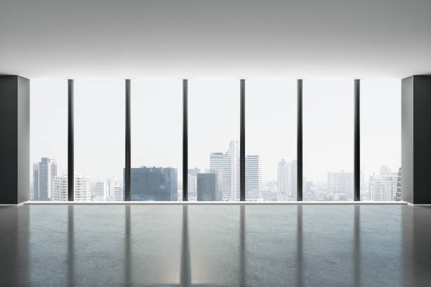 istock City skyscrapers view from glass window from light spacious hall with concrete floor. 1205615108