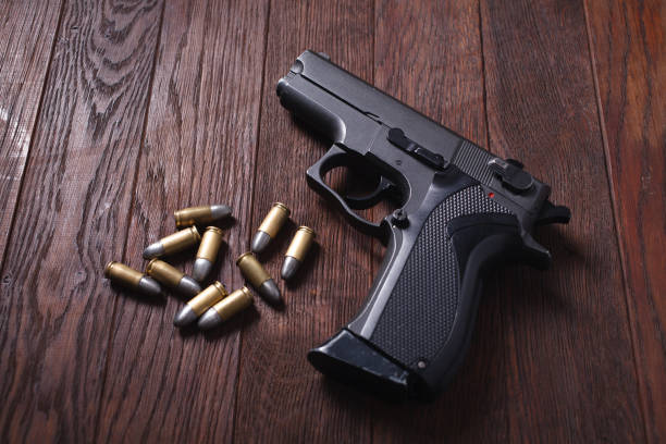 istock handgun on wooden table 1205615670