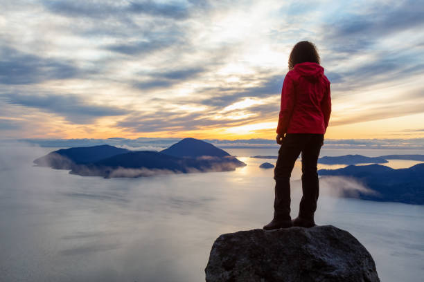 istock Adventurous Girl on top of a Mountain during Sunset 1205618554