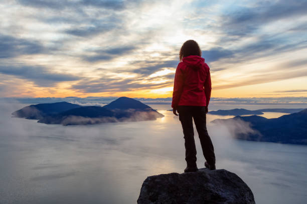 istock Adventurous Girl on top of a Mountain during Sunset 1205618557