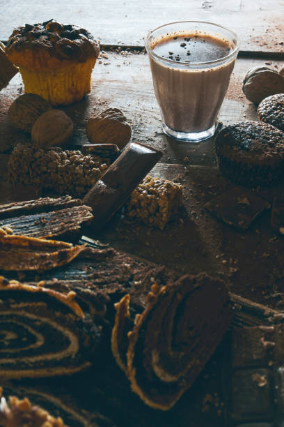 Chocolate, brownie and milk on a wooden background