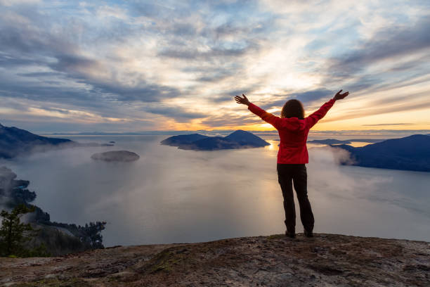 istock Adventurous Girl on top of a Mountain during Sunset 1205618692