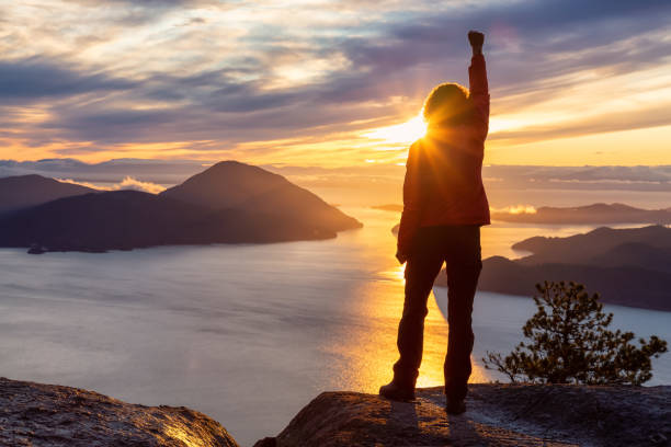 istock Adventurous Caucasian Girl standing on top of a mountain 1205618708