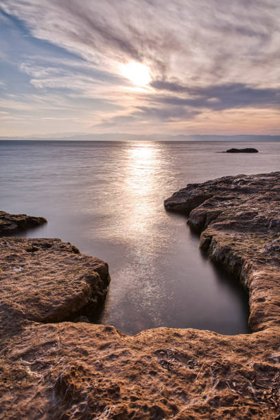 istock long exposure of seaside cliffs at sunset 1205620131
