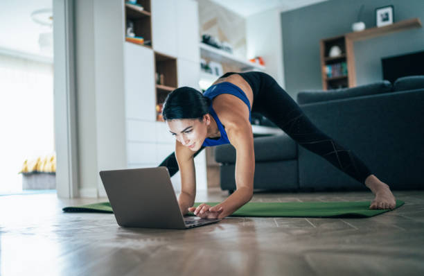 istock Woman working out at home 1205621188