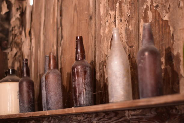 istock Close Up Of Old Dusty Empty Bottles On A Shelf 1205625413