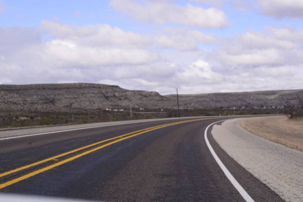 Winding Road With Double Yellow Lines Winding Through Semi-Arid Mountainous Landscape