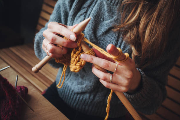 istock Close up on woman's hands knitting 1205627075
