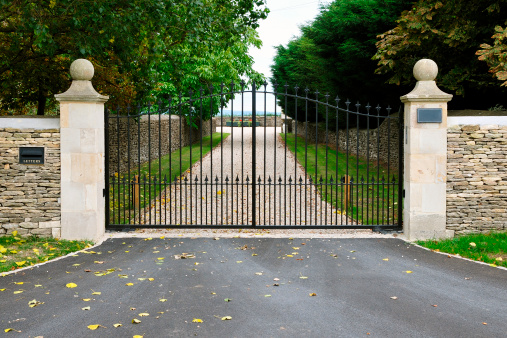 Poslingford, Suffolk, England - June 22 2016: Open gate to driveway and garage in village