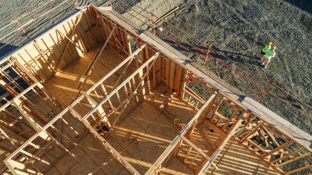 istock Drone Aerial View of Home Construction Site With Pilot Below 1205632286
